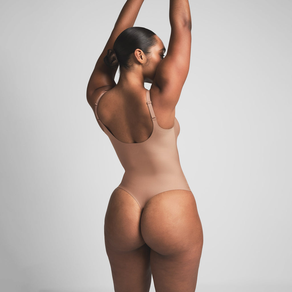 SKIMS BODY UNLINED PLUNGE THONG BODYSUIT | SIENNA