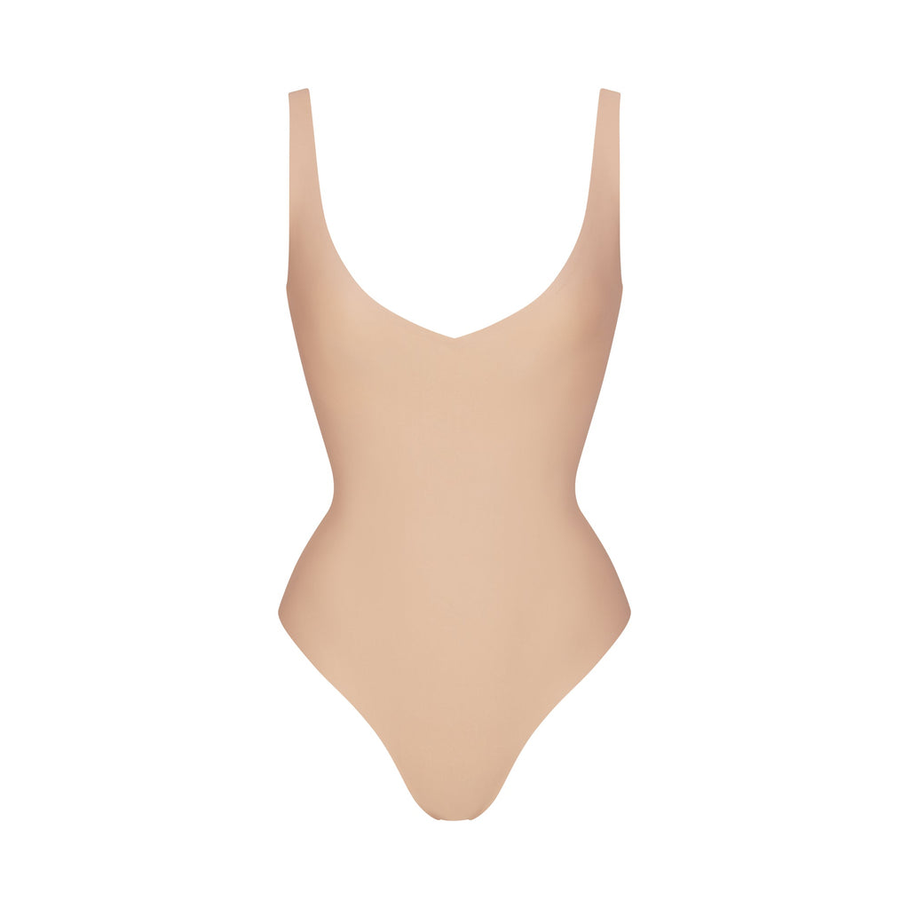 SKIMS BODY UNLINED PLUNGE THONG BODYSUIT | CLAY